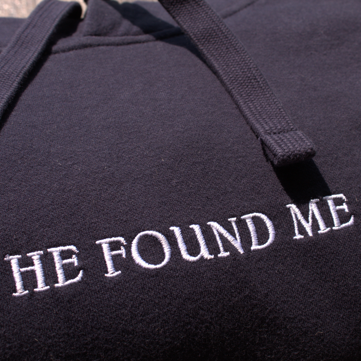 Navy blue hoodie with embroidered 'HE FOUND ME' text in white