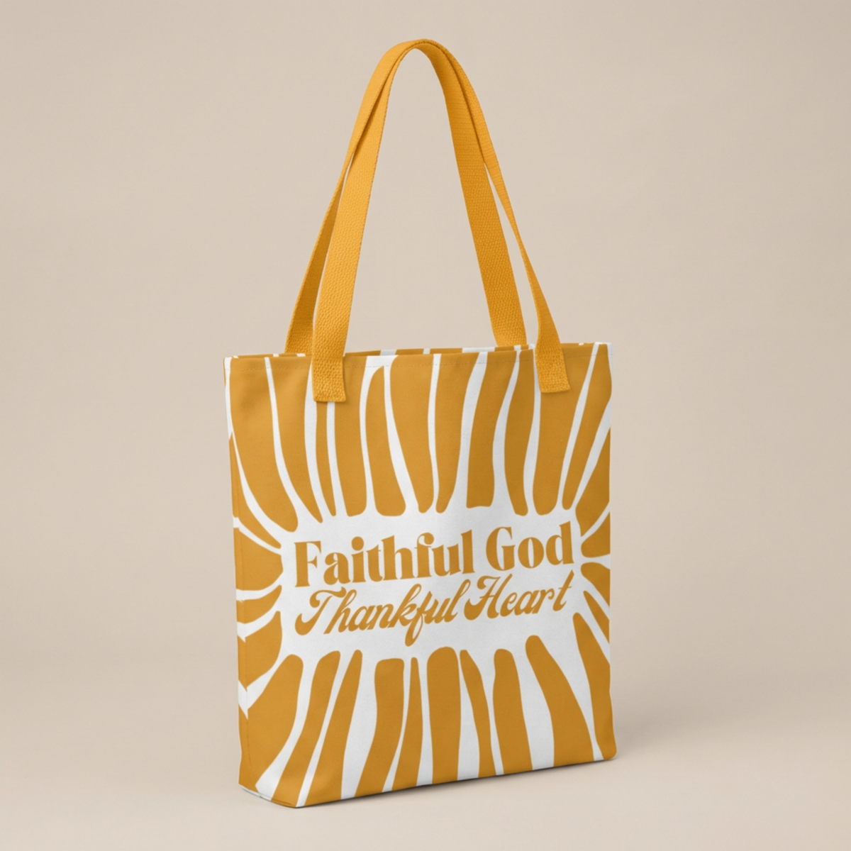 Yellow tote bag with 'Faithful God Thankful Heart' text and a fun stripe design displayed on a beige background