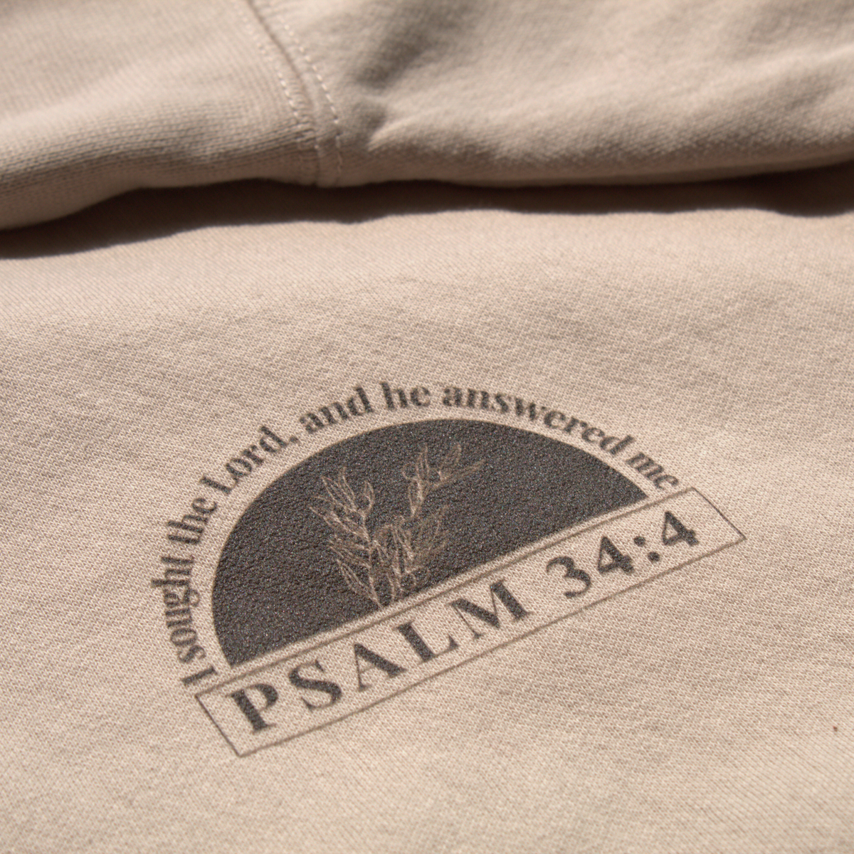 Close up of the front logo featuring 'Psalm 34:4' text and verse, along with the olive branch graphic
