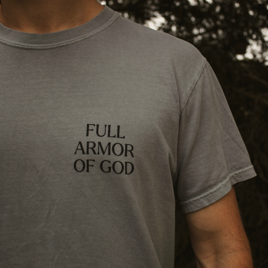 Gray t-shirt with 'Full Armor of God' text worn by a person outdoors.