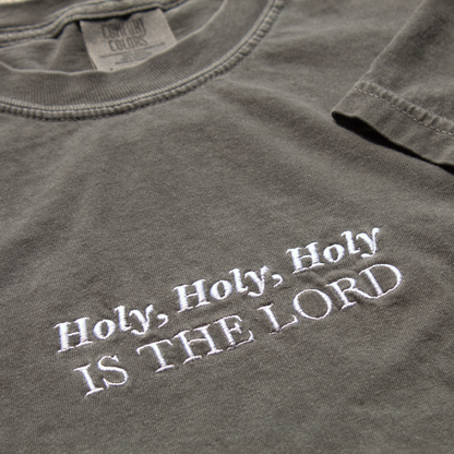 close up of Gray t-shirt with 'Holy, Holy, Holy IS THE LORD' text in white embroidery.