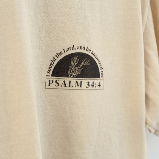 light tan tee with a printed design featuring 'I sought the Lord, and he answered me' and 'Psalm 34:4'.