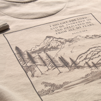 light tan sweatshirt close up of the back with mountain scene design and Psalm 34:4 text